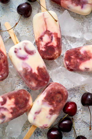 Delicious, homemade  made from cherries and cream. Placed on ice cubes background. Flat lay, top view.の写真素材