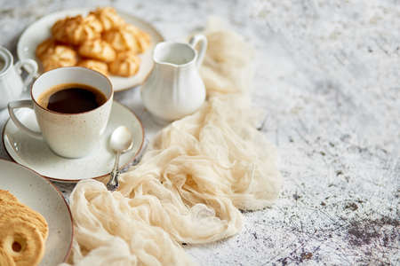 Side view of delicious dessert served. Butter and coconut cookies with cup of black coffeeの写真素材