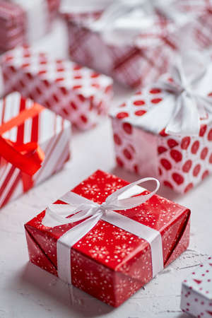 Christmas concept. Close up on festive paper wrapped gifts with ribbonの写真素材