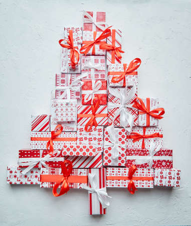 Colorful Christmas tree formed from different various pattern and size boxed gifts