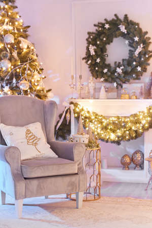 Beautiful Christmas interior decoration for family celebration with pine tree, armchair, fireplaceの写真素材