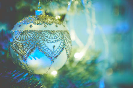 Colorful christmas ornaments and decorations hanging from christmas treeの写真素材