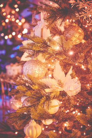 Colorful christmas ornaments and decorations hanging from christmas treeの写真素材