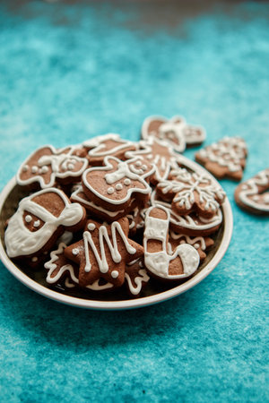 Delicious fresh Christmas decorated gingerbread cookies placed in wooden crateの写真素材