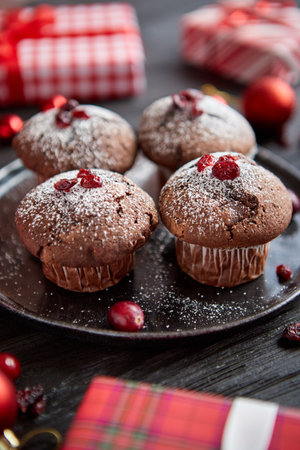 Christmas chocolate delicious muffins served on black ceramic plateの写真素材