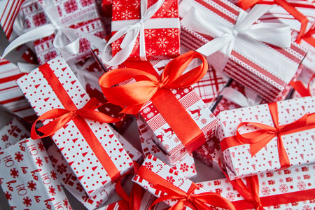 Christmas concept. Close up on festive paper wrapped gifts with ribbonの写真素材