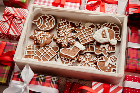 Delicious fresh Christmas decorated gingerbread cookies placed in wooden crateの写真素材