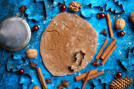 Christmas baking concept. Gingerbread dough with different cutter shapesの写真素材