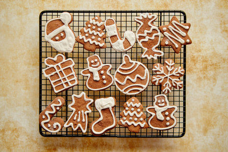 Fresh baked Christmas shaped gingerbread cookies placed on steel grillの写真素材
