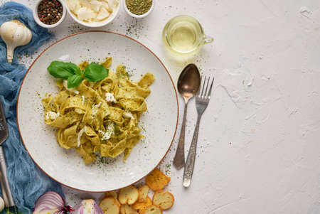 Tasty tagliatelle pasta with basil and green pestoの写真素材