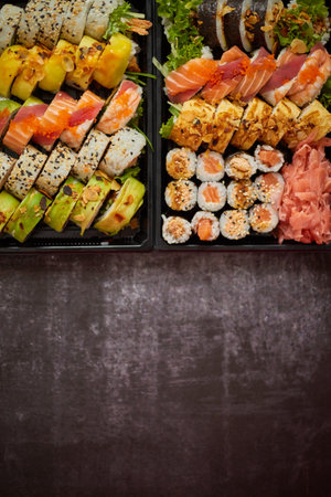 Sushi take-away plastic tray with diffent kinds of rolls and copy space. Take-away food concept.の写真素材