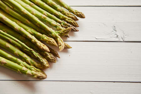 Above view of flat-lay organic raw uncooked green asparagusの写真素材