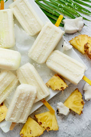 Homemade vegan ice cream made with coconut milk and pineapple. Delicious healthy summer snackの写真素材