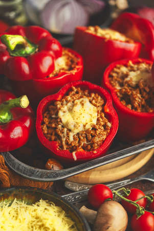 Red peppers stuffed with beef meet and mozarella cheese with herbs and garlicの写真素材