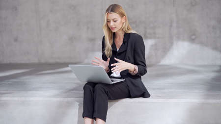 Blond businesswoman making video callの写真素材