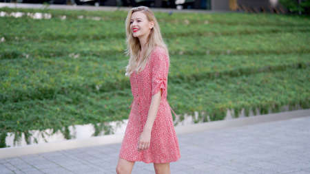 Cheerful woman walking in parkの写真素材