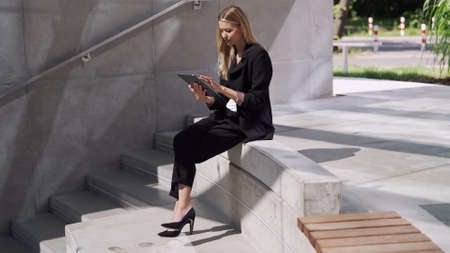 Female manager using tablet on stepsの写真素材