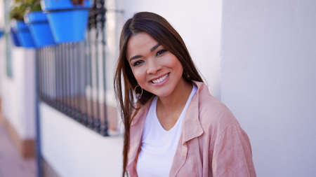 Smiling woman in casual wear on streetの写真素材