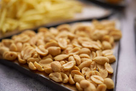 Raw pasta on tray on tableの写真素材