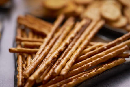 Close up of Salty sticks on a plate with crackersの写真素材