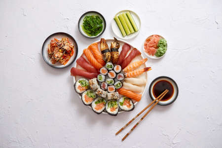 Various sushi rolls placed on round ceramic plateの写真素材