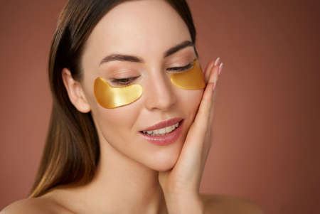 Smiling woman with eye patchesの写真素材