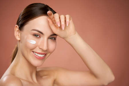 Smiling woman with moisture creamの写真素材