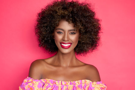 Cheerful black woman with curly hairの写真素材
