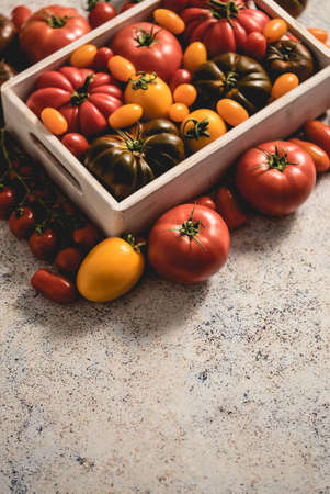 Assortment of tomatoes in a wooden boxの写真素材