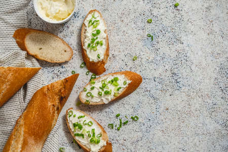 Fresh and delicious crispy baguette with cream cheese and chivesの写真素材
