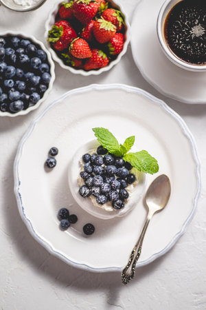 Delicious mini Pavlova meringue nest with blueberry and mint leavesの写真素材