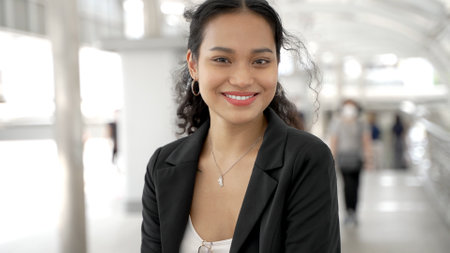 Portrait of asian businesswoman standing outside of office buildingの写真素材