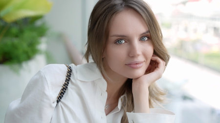 Elegant Caucasian Woman with Positive Smile Looking at Cameraの写真素材