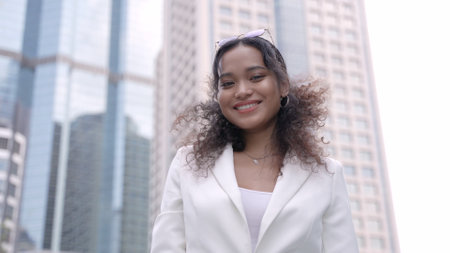 Smiling Businesswoman Outside Corporate Skyscraper in the City.の写真素材