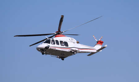 Helicopter with the passenger onboard in the skyの写真素材