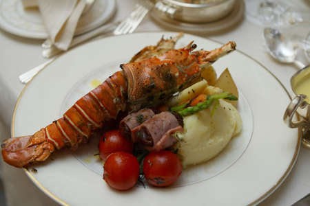Beautifully plated gourmet lobster dinner on the tableの写真素材