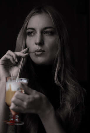 The girl drinks coffee. Black and whiteの写真素材