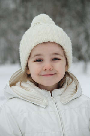 A cute little girl in the winter parkの写真素材
