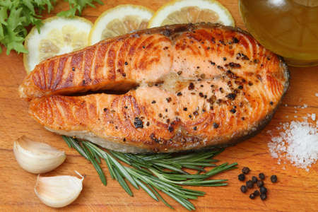 Still life with salmon fried with spices and a lemonの写真素材