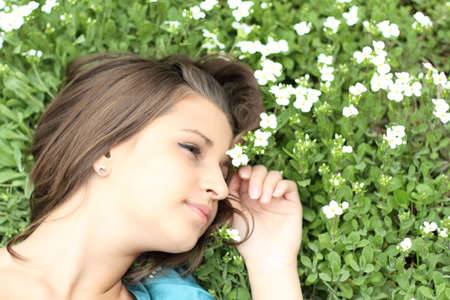 Portrait of the young girl on the flower  backgroundの写真素材