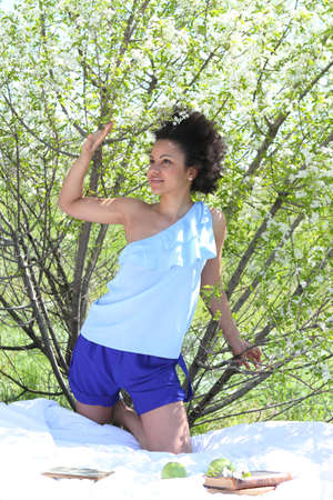 A beautiful mixed race African American girl in the spring gardenの写真素材