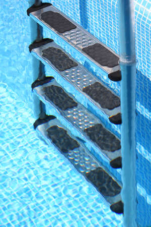Stairs of the swimming pool in the waterの写真素材