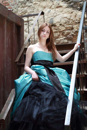 Red haired girl on the stairsの写真素材