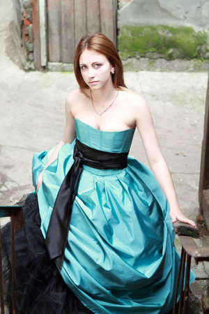 Romantic girl in the beautiful dress on the stairsの写真素材