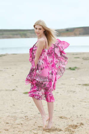 Beautiful romantic girl on the yellow sandの写真素材