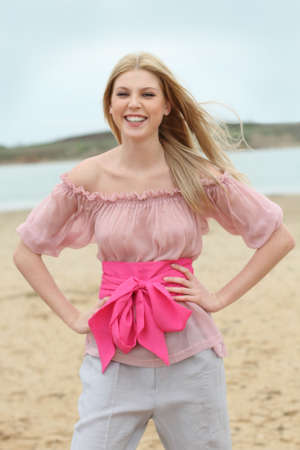 Beautiful blond laughing girl on the beachの写真素材