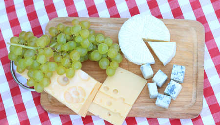 Various sorts of cheese with white grapesの写真素材