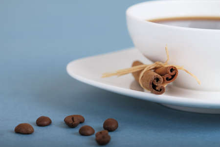 Coffee beans and cup of coffee with cinnamonの写真素材