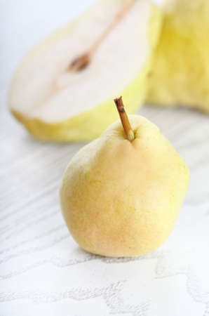 Three yellow pears on the white wooden backgroundの写真素材