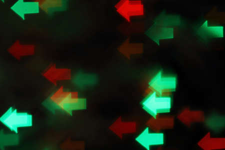 Blurred background with green and red lights on blackの写真素材